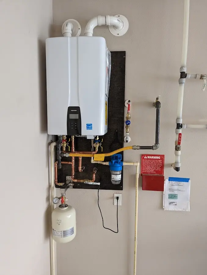 Professional plumber installing copper piping in a Upper Arlington home